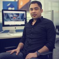 Adrian Cruz sitting on a chair inside Promet Source office in Cebu.